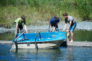 Image of 3 Northlake youth members boating during camping trip