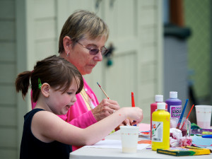 Image of child and adult working on an art project together
