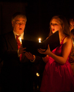 Image of Art and Emily singing in candlelight