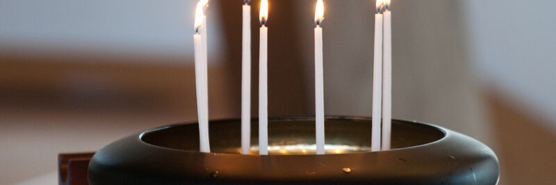 Image of candles burning in a presentation bowl