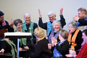 Image of choir members laughing with each other
