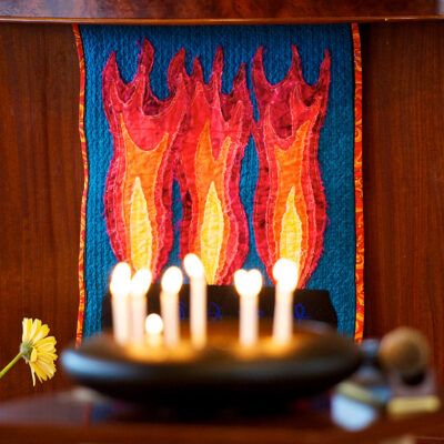 candles burn in a bowl background quilt with flames